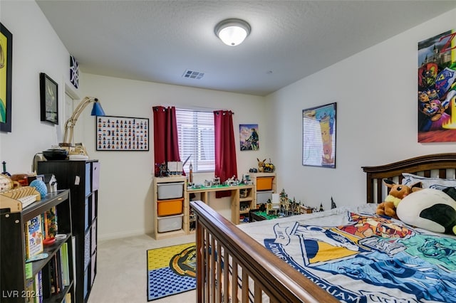 bedroom with light carpet, baseboards, visible vents, and a textured ceiling