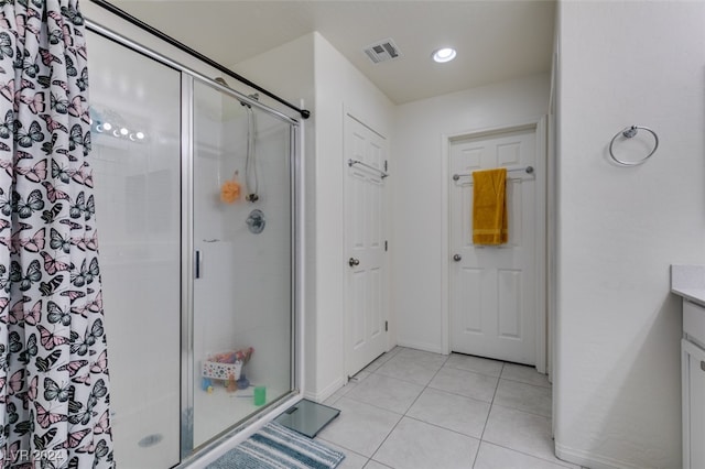 bathroom with visible vents, baseboards, tile patterned floors, vanity, and a shower stall