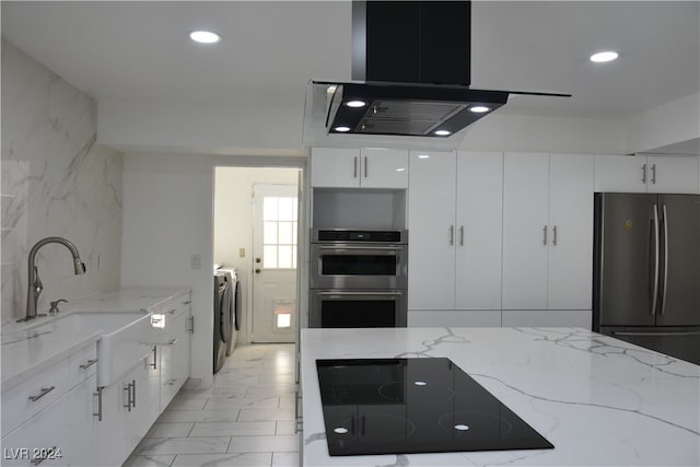 kitchen with white cabinetry, sink, stainless steel appliances, light stone counters, and exhaust hood