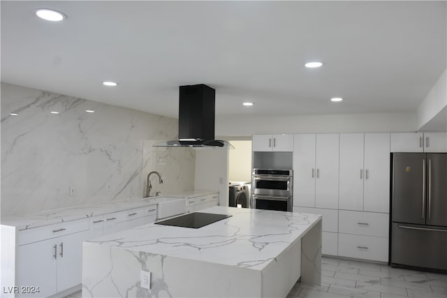 kitchen featuring ventilation hood, a center island, white cabinets, and appliances with stainless steel finishes