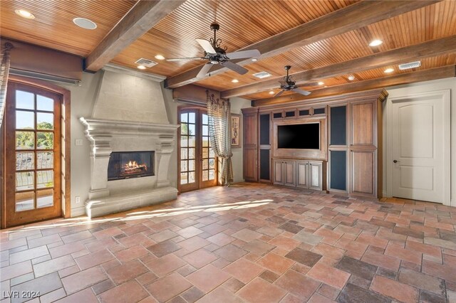 unfurnished living room with tile patterned flooring, ceiling fan, a large fireplace, and wood ceiling