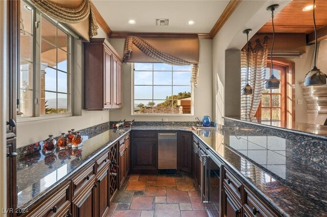 kitchen featuring sink, dark stone countertops, dark tile patterned floors, and pendant lighting