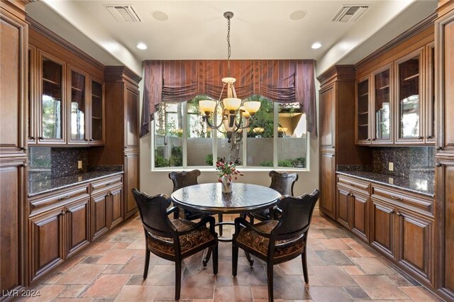 dining space with a chandelier and light tile patterned floors