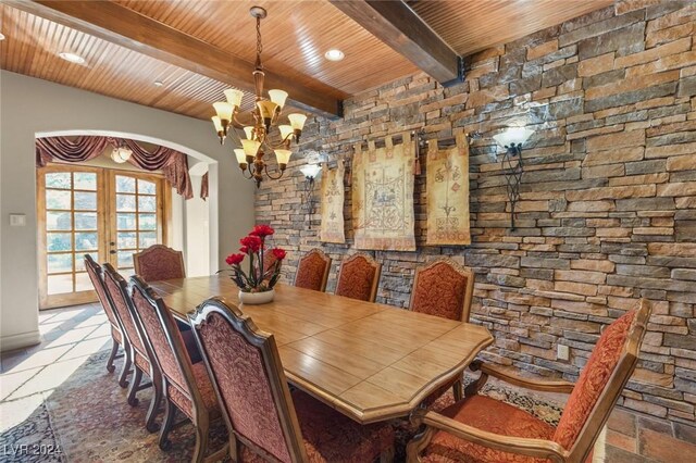 tiled dining area featuring wooden ceiling, a notable chandelier, french doors, and beamed ceiling