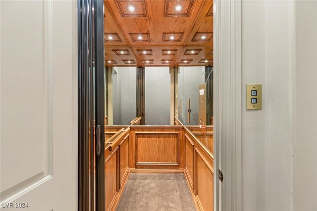 details featuring carpet, coffered ceiling, and elevator