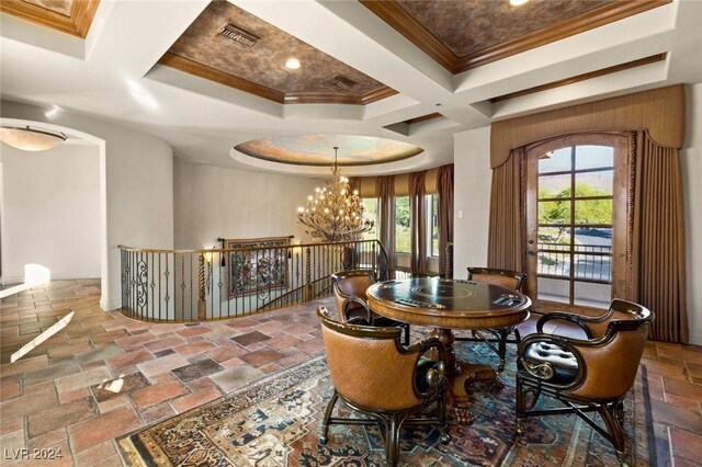 tiled dining space with coffered ceiling, plenty of natural light, an inviting chandelier, and a raised ceiling