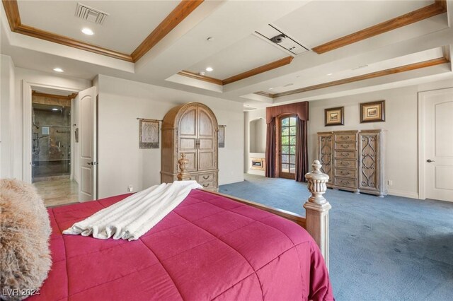 carpeted bedroom with crown molding and a tray ceiling