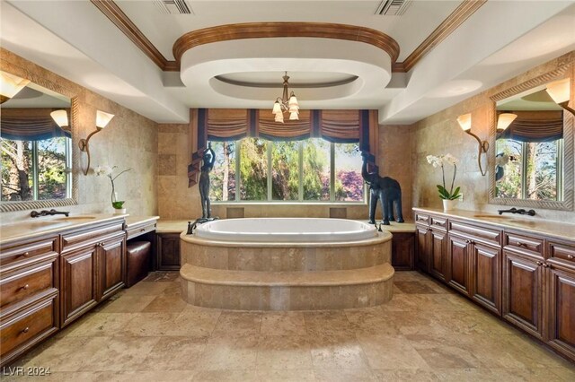 bathroom featuring a bath, tile patterned floors, a tray ceiling, and vanity