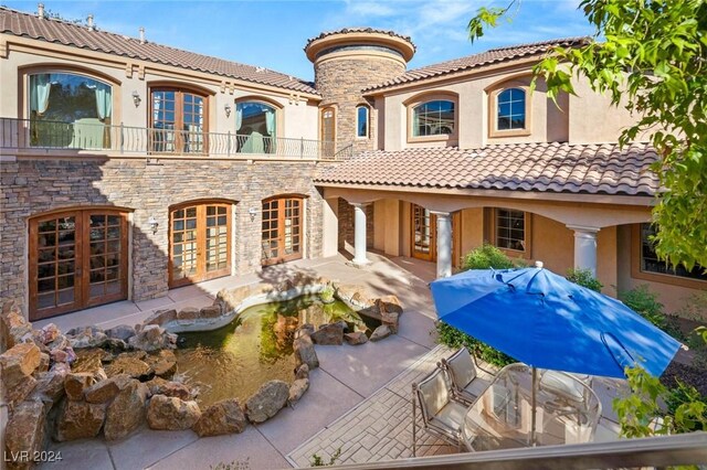 exterior space featuring a patio, french doors, and a balcony