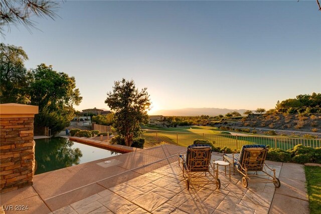 view of patio terrace at dusk