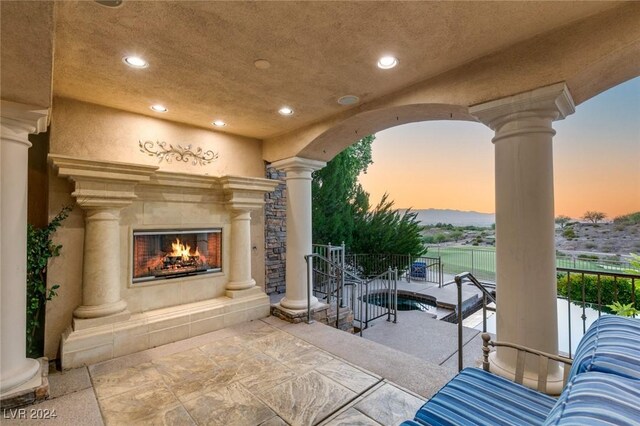 patio terrace at dusk with a tiled fireplace