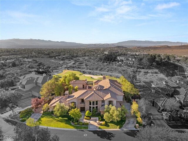 birds eye view of property with a mountain view