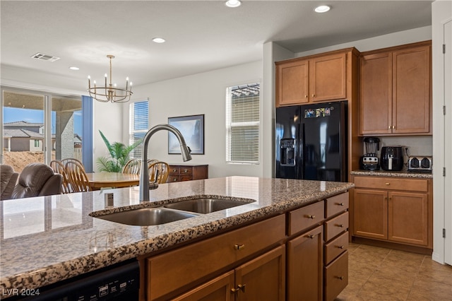 kitchen featuring decorative light fixtures, black appliances, light tile patterned floors, sink, and plenty of natural light