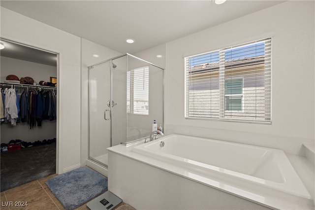 bathroom with shower with separate bathtub and tile patterned floors