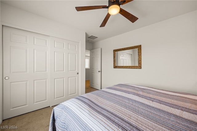 carpeted bedroom featuring ceiling fan and a closet