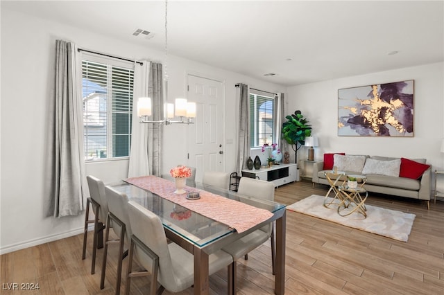 dining space with a notable chandelier and wood-type flooring