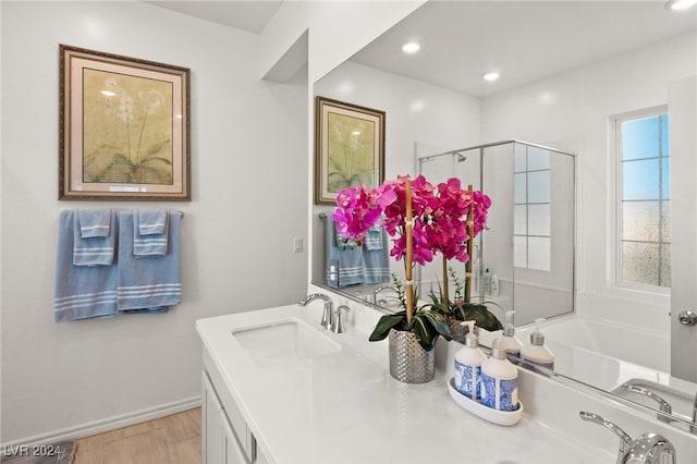 bathroom with separate shower and tub and vanity