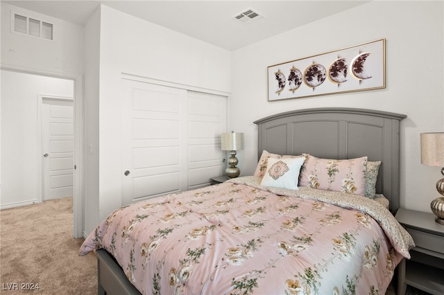 bedroom featuring a closet and light carpet