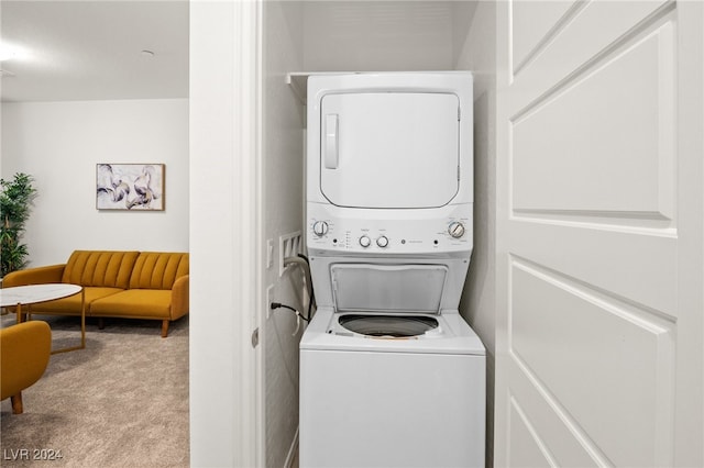 washroom featuring stacked washer and dryer and light carpet