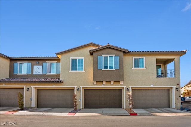 view of front of property with a balcony and a garage