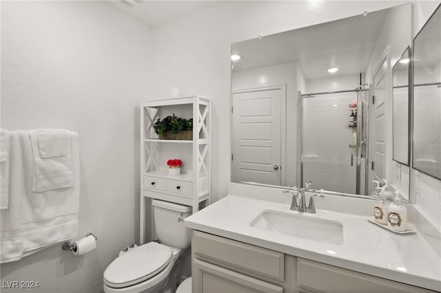 bathroom featuring an enclosed shower, toilet, and vanity