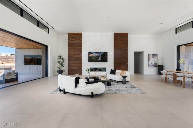 living room with light tile patterned floors and a high ceiling