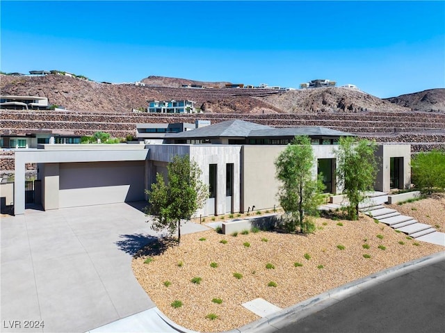 view of front facade featuring a garage and a mountain view