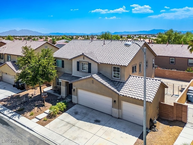 view of front of house with a mountain view and a garage