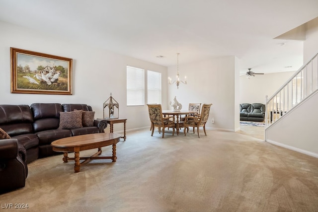 living room with ceiling fan with notable chandelier and light colored carpet