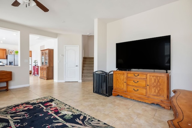 tiled living room featuring ceiling fan