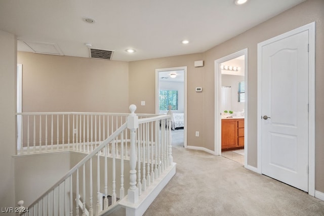 corridor featuring light colored carpet