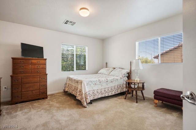 bedroom with light colored carpet