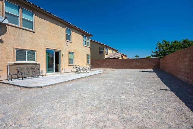 back of property featuring a patio