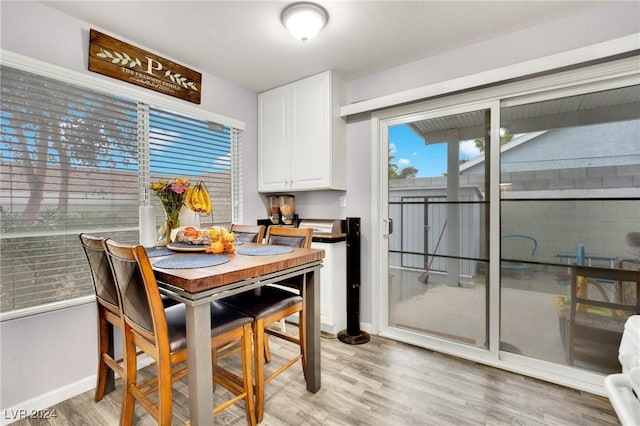 dining room with baseboards and light wood-style floors