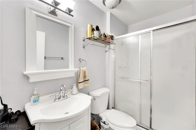 full bathroom with toilet, a stall shower, and vanity