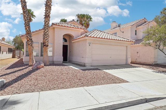 mediterranean / spanish-style house featuring a garage