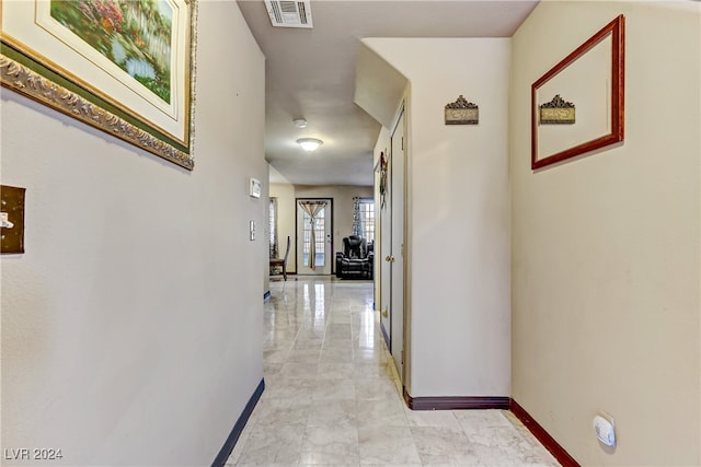 corridor with light tile patterned floors