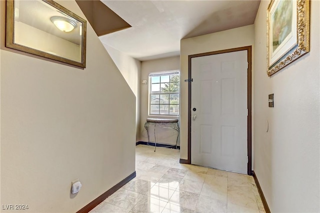 entryway featuring baseboards