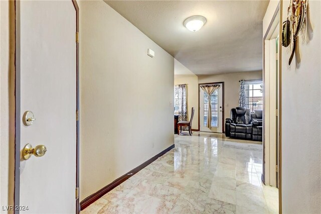 corridor featuring light tile patterned flooring