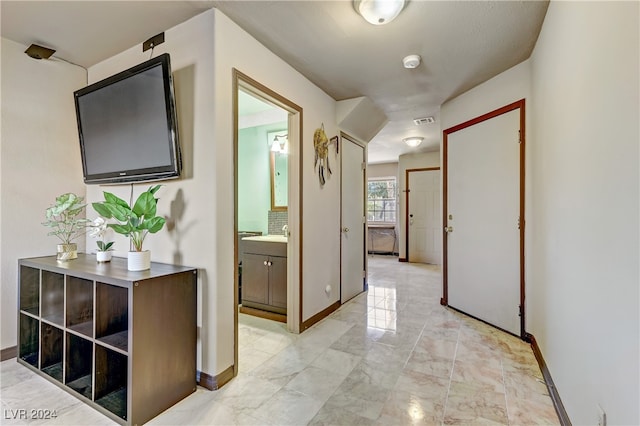 corridor with light tile patterned floors