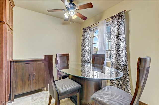 tiled dining area with ceiling fan