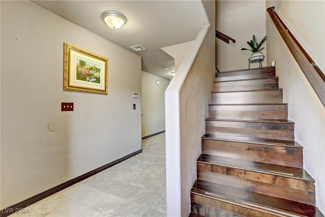 staircase with tile patterned flooring