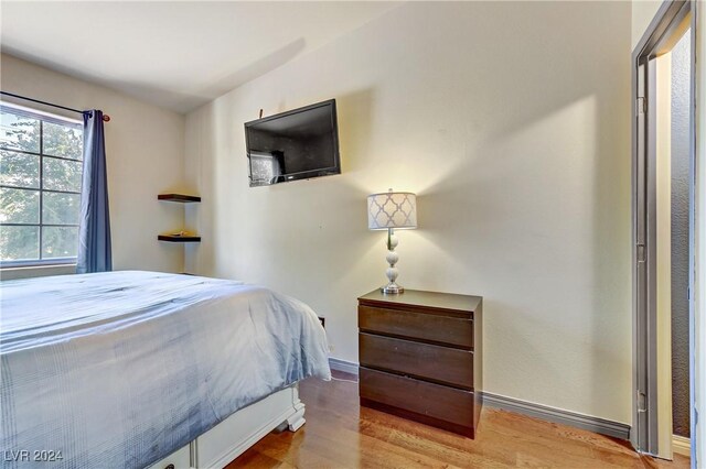 bedroom featuring light wood-type flooring and baseboards