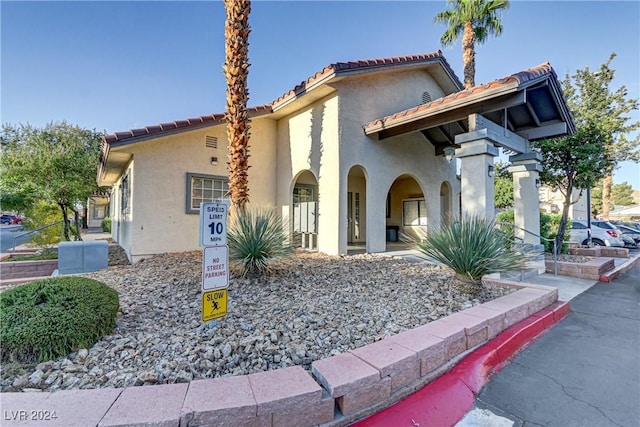 mediterranean / spanish-style house with a tile roof and stucco siding