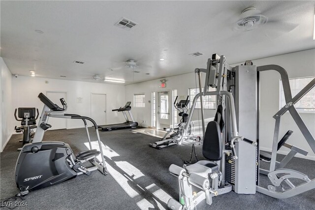 workout area featuring ceiling fan, visible vents, and baseboards