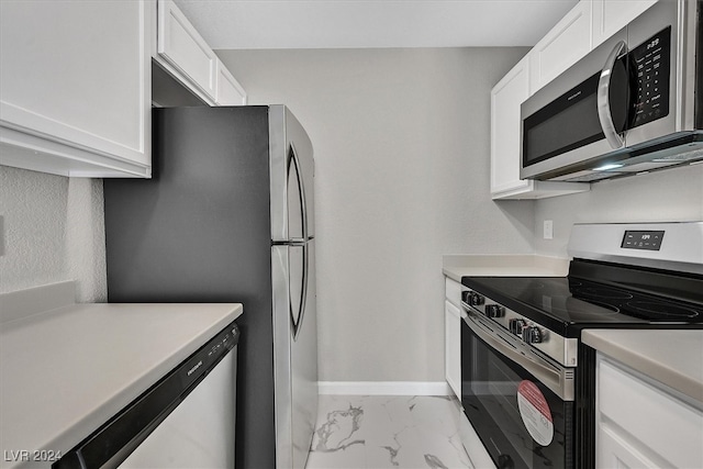 kitchen featuring white cabinetry, light tile patterned flooring, and stainless steel appliances