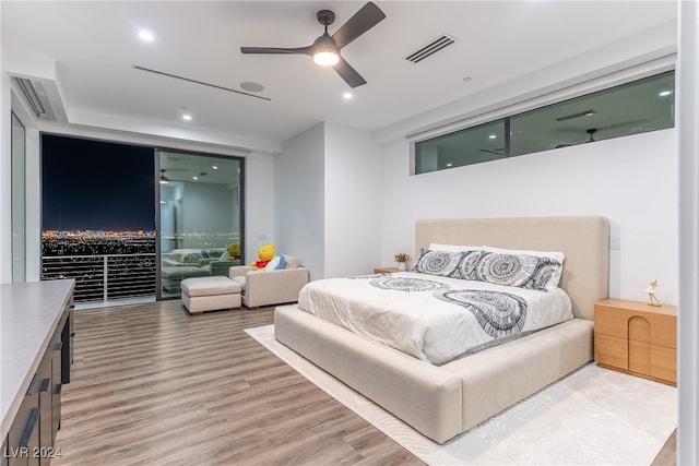 bedroom with ceiling fan and hardwood / wood-style floors