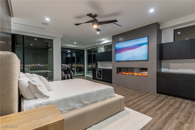 bedroom with ceiling fan and hardwood / wood-style flooring