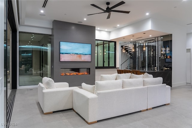 living room with ceiling fan and bar