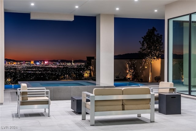 patio terrace at dusk featuring outdoor lounge area